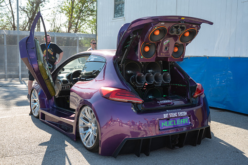Montmelo, Spain – October 20, 2023: An unrecognizable Peugeot 206 GTI fully tuned with scissor doors. It is full of speakers with sound power, parking music