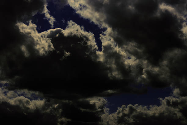 at dusk, Dramatic stormy dark cloudy sky: Dramatic stormy dark cloudy sky over sea, natural photo background. Beautiful storm clouds on a summer night with pinks and blues.