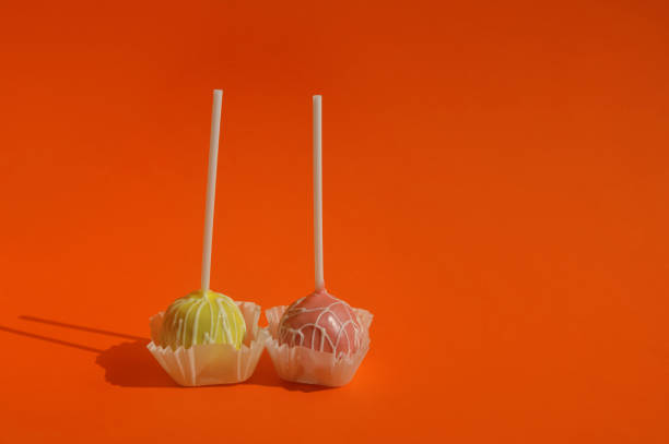 istock candy on a stick, cake pops, sweet cake in colored glaze. dessert. background for the design 2135604663