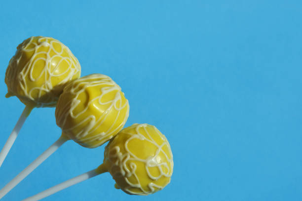 delicious candy on a stick, cake pops, sweet cake in colorful bright chocolate glaze. dessert. background for the design