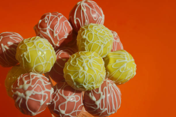delicious candy on a stick, cake pops, sweet cake in colorful bright chocolate glaze. dessert. background for the design