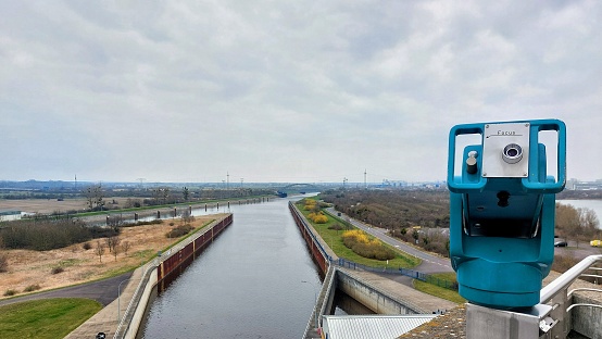 View over canals near Magdeburg with coin-operated binoculars in foreground.