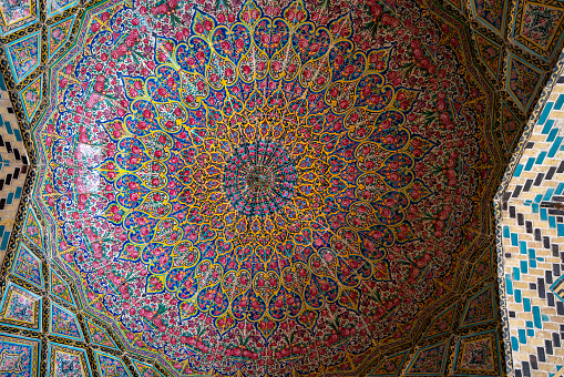 Shiraz, Iran - February 29, 2024: The interior of the Nasir al-Mulk Mosque(Pink Mosque), is adorned with a floral pattern composed of seven-colored tiles, a hallmark of Persian architecture.