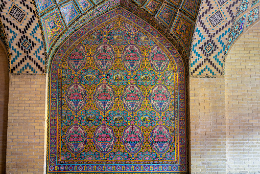 Shiraz, Iran - February 29, 2024: The interior of the Nasir al-Mulk Mosque(Pink Mosque), is adorned with a floral pattern composed of seven-colored tiles, a hallmark of Persian architecture.