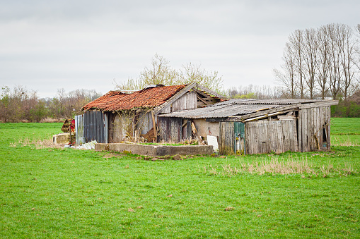 Scenic view of a farm shed in decay in the Dutch countryside.