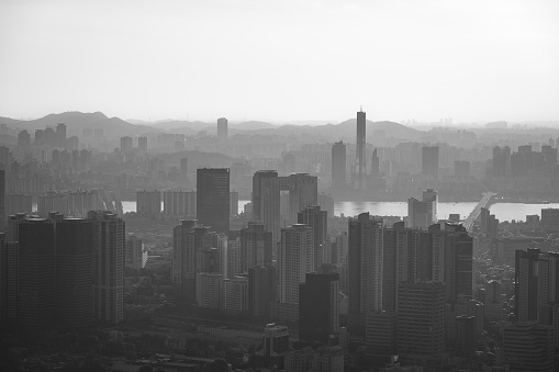 Witness the stunning aerial panorama of Seoul, South Korea's bustling capital, captured in the golden hues of sunset.