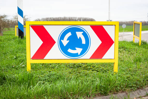 Roundabout with traffic sign in the middle.