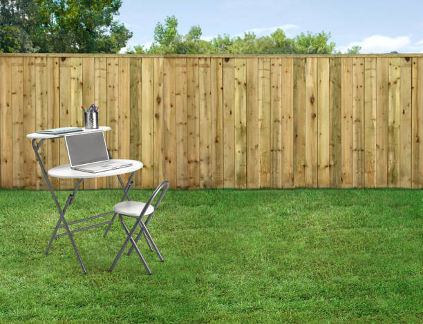 istock Empty backyard with green grass and wood fence 2135650173