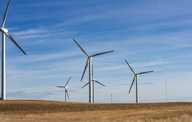 istock Five Wind Turbines on Southern Alberta prairie with two communication tours in background 2135660294
