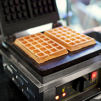Freshly baked waffles in a professional waffle machine