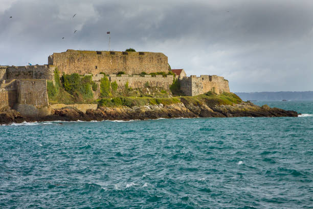 UK - Guernsey - St Peter Port - The impregnable walls and towers of castle cornet among sea waves