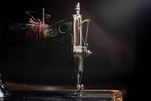 istock Old sewing machine stands on the table at home ready to work and sew. 2135680511