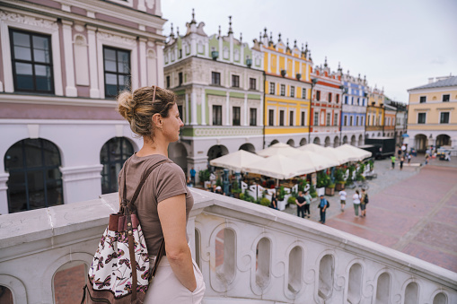 Woman looking at rynek square in Zamosc city Poland