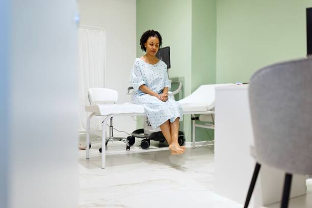 istock Front view of a woman sitting on the exam table. 2135684106