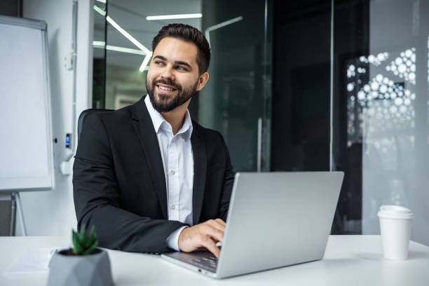 istock busy business man typing on laptop computer working online at desktop in the office Concentrated entrepreneur takes responsible approach to the project indoors 2135684514