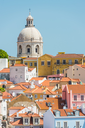 The terracotta rooftops of the iconic Alfama district overlooked by the dome of the Panteao Nacional in the heart of Lisbon, Portugal’s vibrant capital city.