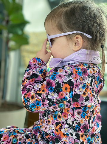 Toddler girl showing her new Sunglasses