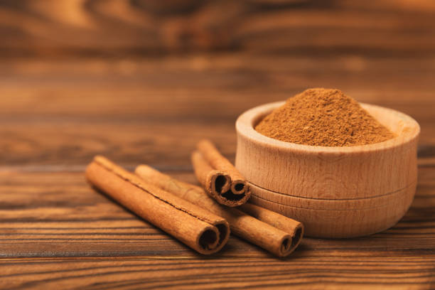 istock Cinnamon sticks on a textured wooden background. Cinnamon roll. Spicy spice for baking, desserts and drinks. Fragrant ground cinnamon. cinnamon powder Close-up. Place for text. copy space 2135713310