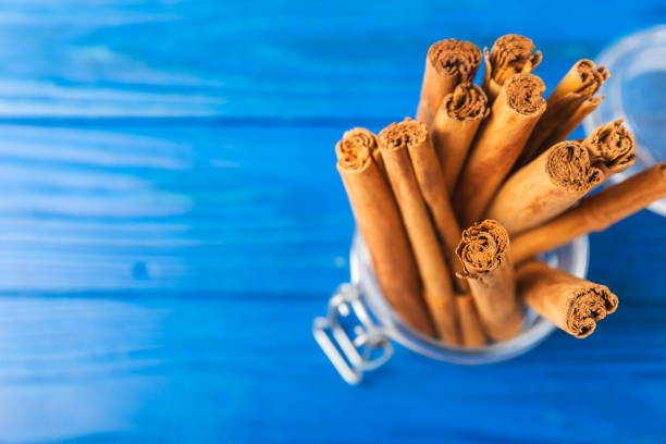 Ceylon cinnamon.Cinnamon sticks on a textured wooden background. Cinnamon roll and powder. Spicy spice for baking, desserts and drinks. Fragrant ground cinnamon. Close-up. Place for text. copy space