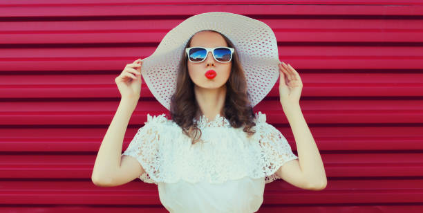 istock Beautiful young woman model posing in white summer straw hat 2135724045