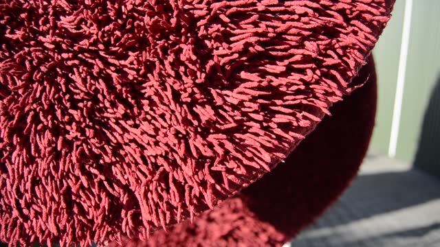 Closeup red bath mat.