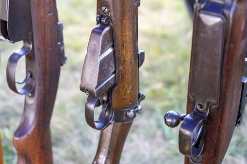 A close-up of the magazine and firing button of World War II rifles