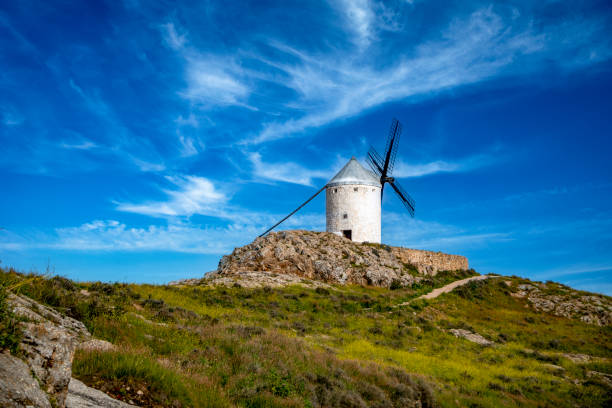 istock Typical Spanish white windmill on a hill with grass in Consuegra 2135751729