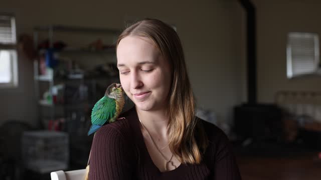 Green Cheek Conure and Young Woman