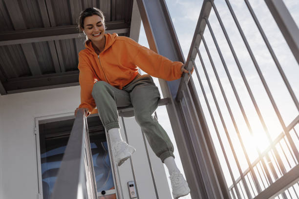 Young Woman Enjoying Sunlight on Urban Staircase