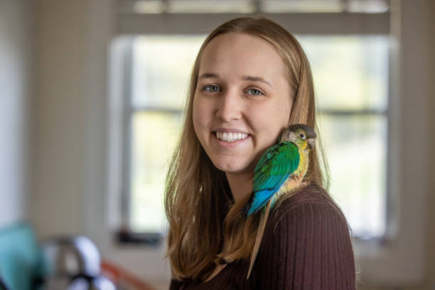 istock Green Cheek Conure and Young Woman 2135765391