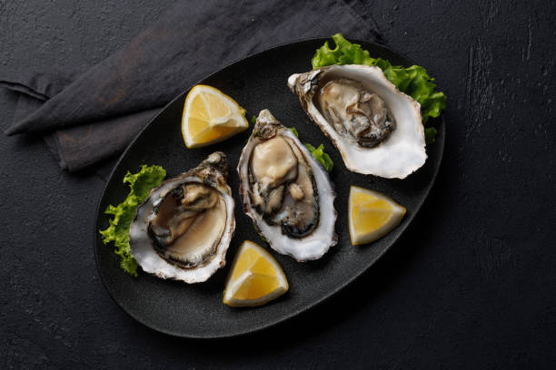 istock Fresh oysters with lemon on plate 2135768550
