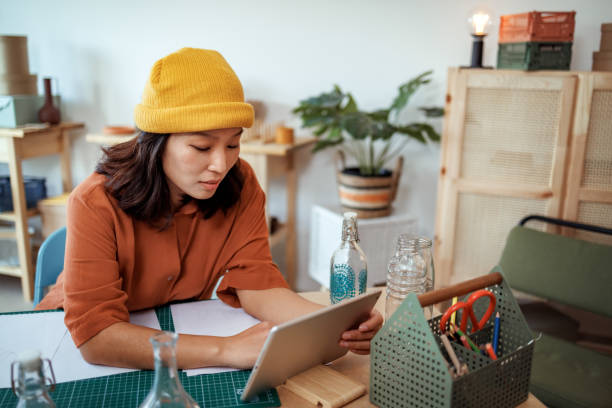 istock Casually clothed woman working at her home based workshop 2135781747