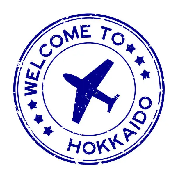 Vector illustration of Grunge blue welcome to hokkaido with airplane icon round rubber seal stamp on white background