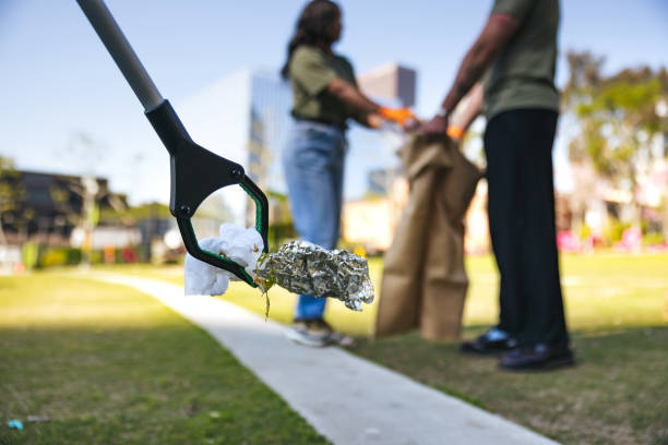 Group of people, volunteering together and cleaning a public park in the city.