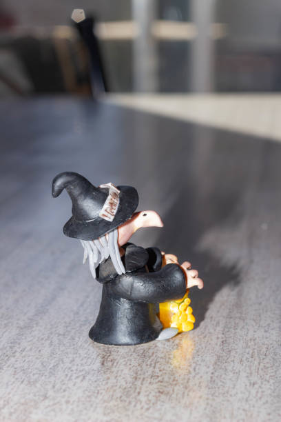 Miniature figure of a witch with a glass of beer in her hand stock photo