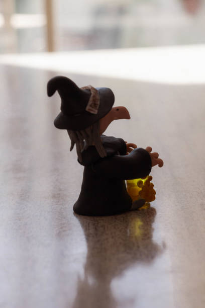 Miniature people: witch and witch on the table. halloween concept stock photo