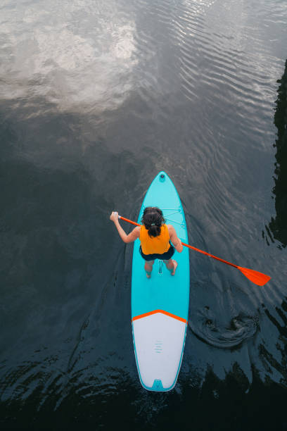 High angle view of woman SUP boarding