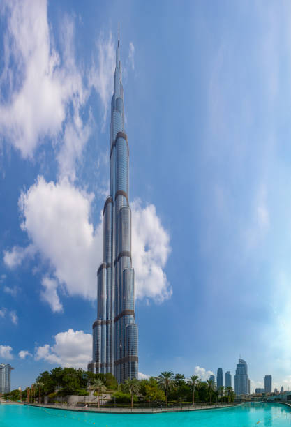 Dubai, United Arab Emirates - November 7, 2023: A picture of the Burj Khalifa towering over the nearby Downtown Dubai buildings and the blue waters of the Burj Khalifa Lake.