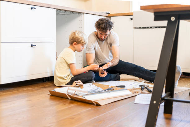 istock Father and son assembling kitchen furniture 2135831605
