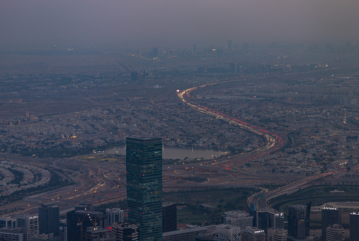 Dubai, United Arab Emirates - November 7, 2023: A picture of the expanse and traffic of Dubai's outskirts at sunset.