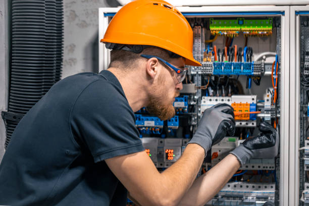 istock Male electrician working in a switchboard with fuses. 2135846559