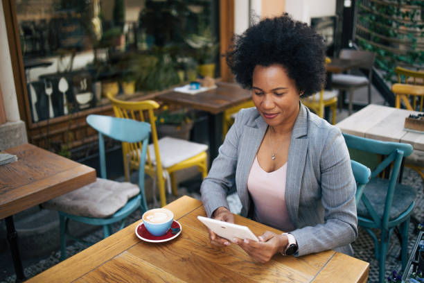 istock Businesswoman sitting at a coffee shop using digital tablet 2135847594
