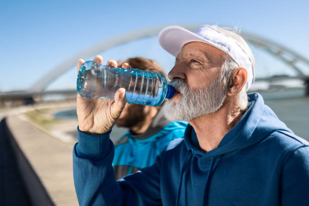 istock Father and Son Finding Peace by the River Hydrating 2135856146
