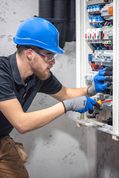 istock A male electrician works in a switchboard with an electrical connecting cable. 2135856682