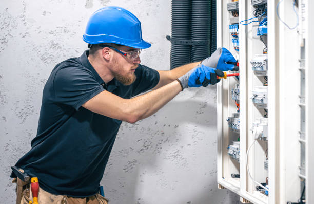 istock A male electrician works in a switchboard with an electrical connecting cable. 2135856684