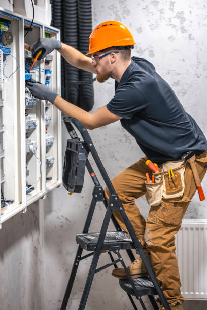 istock A male electrician works in a switchboard with an electrical connecting cable. 2135856685