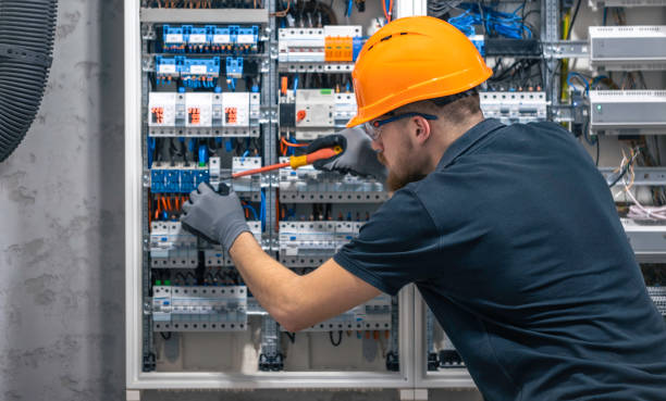 istock A male electrician works in a switchboard with an electrical connecting cable. 2135856687