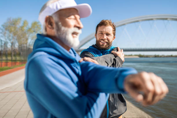 istock Father and Son Enjoying Stretching Along River Run 2135856691