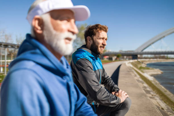 istock Father and Son Relaxing During Jogging Break 2135857083