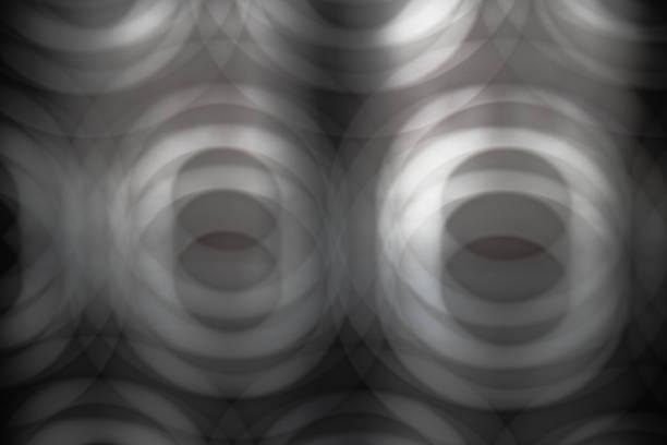 Abstract image in gray tones of multiple blurred circles creating the sensation of depth. Wallpaper, patterns, backgrounds.